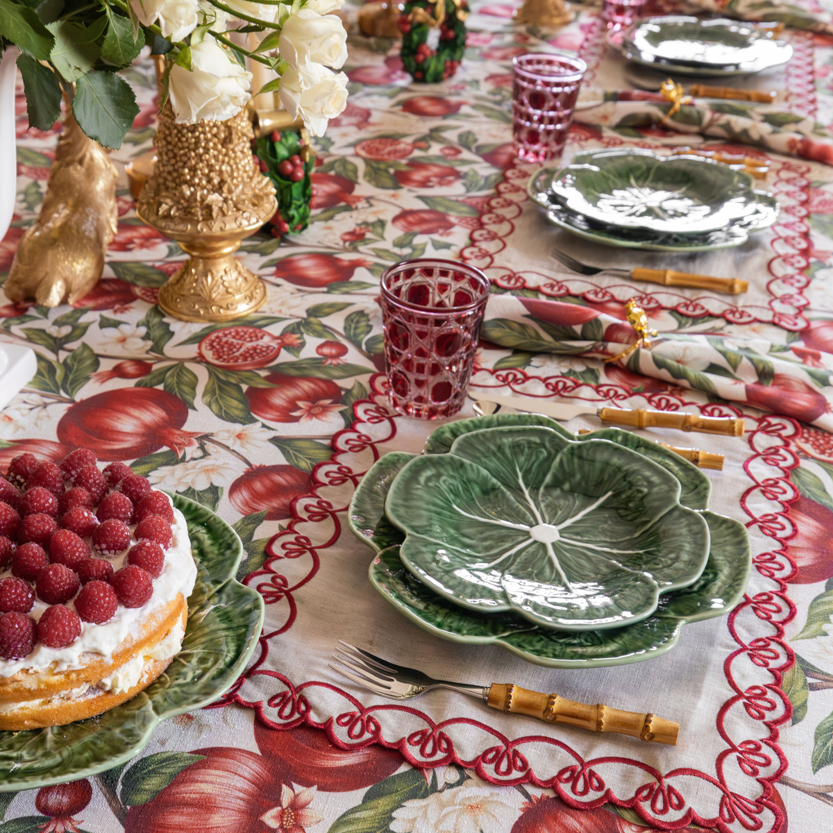 Pomegranate Christmas table styled with Pomegranate table cloth, Pomegranate napkins and natural linen placemats with red embroidery