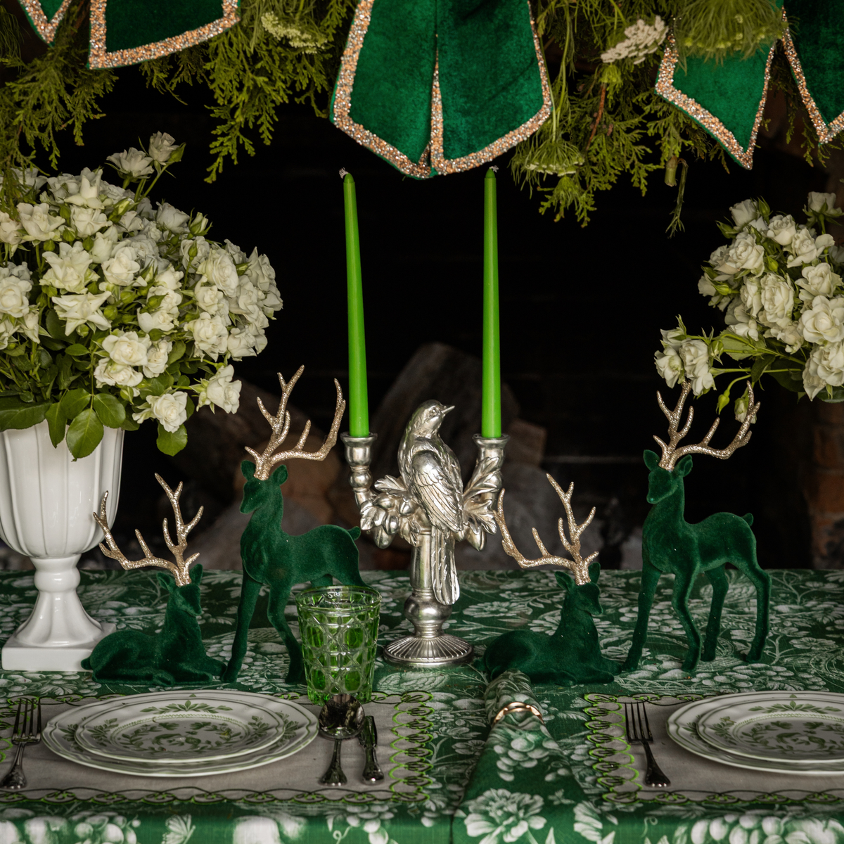 Green Toile Christmas table styled with silver bird double candle holder and dark green velvet reindeer
