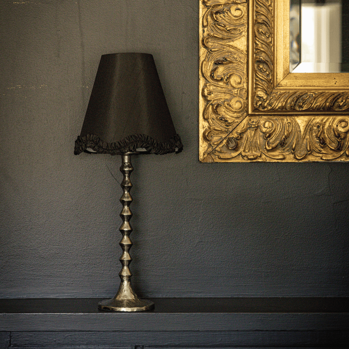 Spruce and Black Bow Christmas table styled with black ruffle lamp shade and silver hammered lamp base