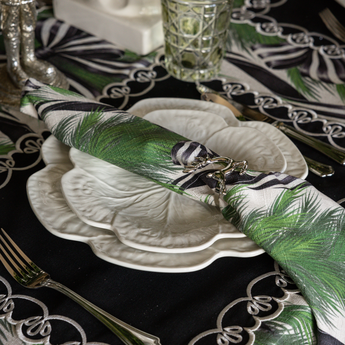 Spruce and Black Bow Christmas table styled with Spruce and Black Bow napkins, white cabbage plates and silver deer napkin rings