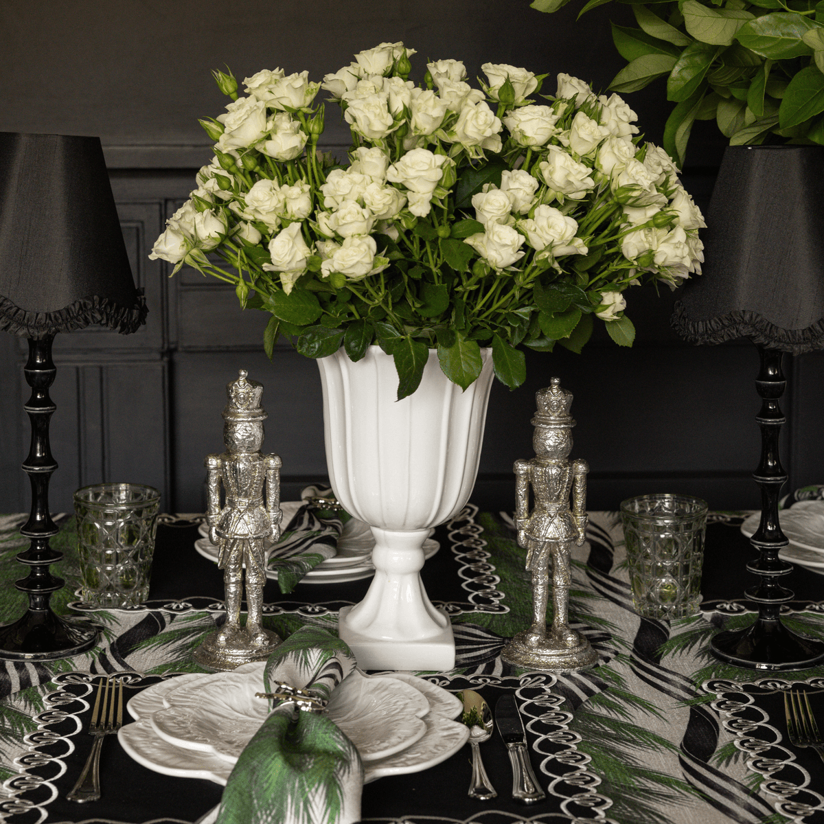 Spruce and Black Bow Christmas table styled with silver nutcrackers, black lamp base and black ruffle lamp shade