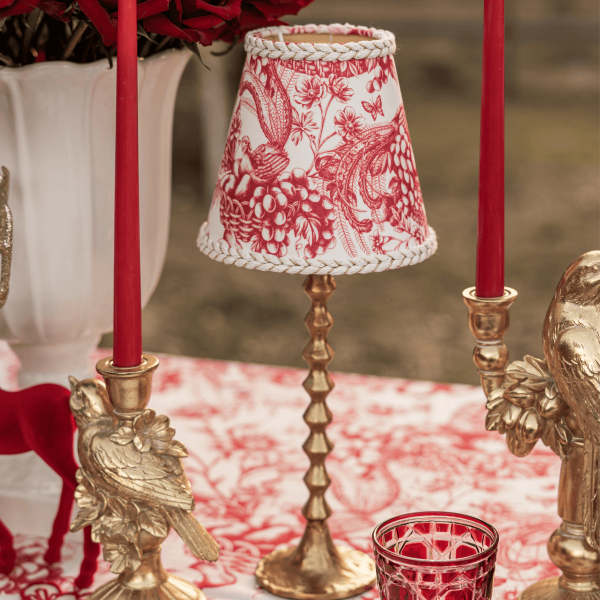 Red Toile Christmas table styled with Red Toile lamp shade, gold hammered lamp base and gold bird candle holders