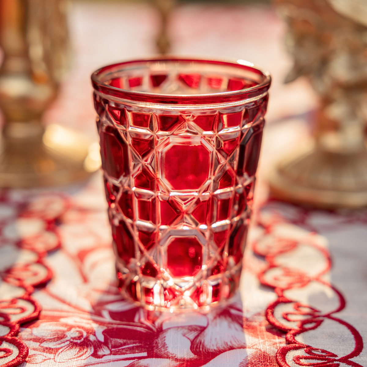 Red Toile Christmas table styled with red geometric glass tumblers