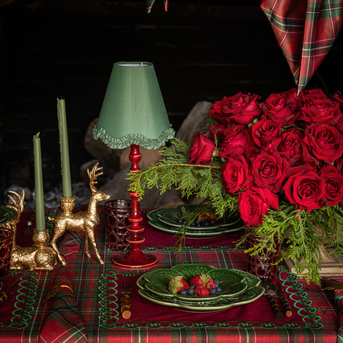 Red Tartan Christmas table styled with Red Tartan table cloth, red placemats with green embroidery and green cabbage plates