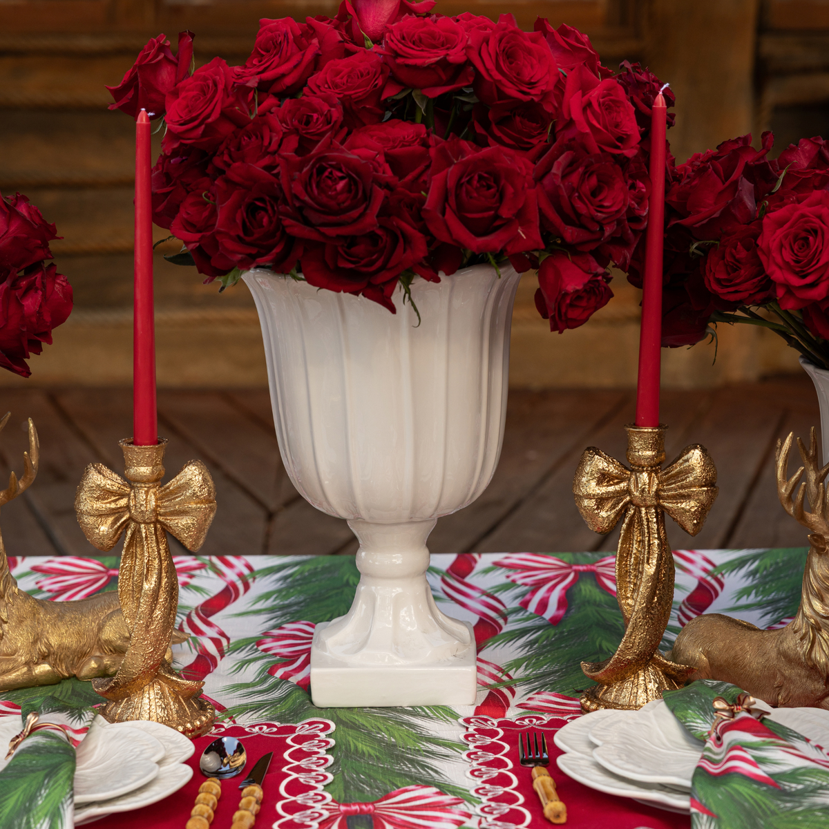 Spruce and Red Bow Christmas table styled with gold bow candle holders