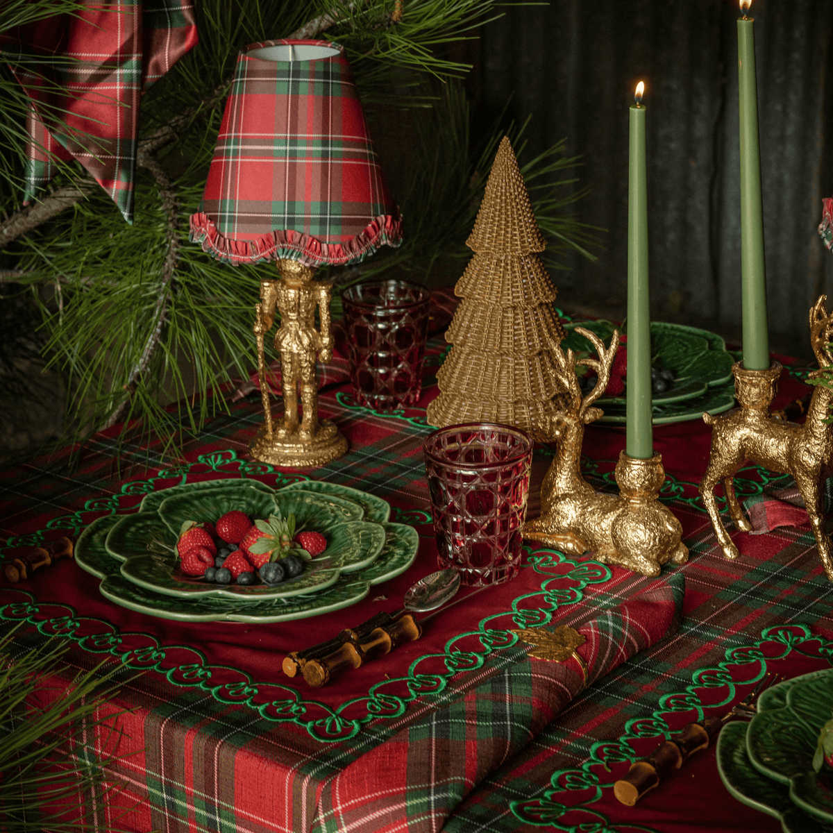 Red Tartan Christmas table styled with Red Tartan ruffle lamp shade, gold nutcracker lamp and dark brown rattan Christmas trees