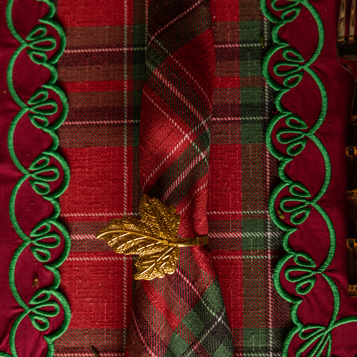 Red Tartan Christmas table styled with gold leaf napkin rings, Red Tartan napkins and red placemats with green embroidery