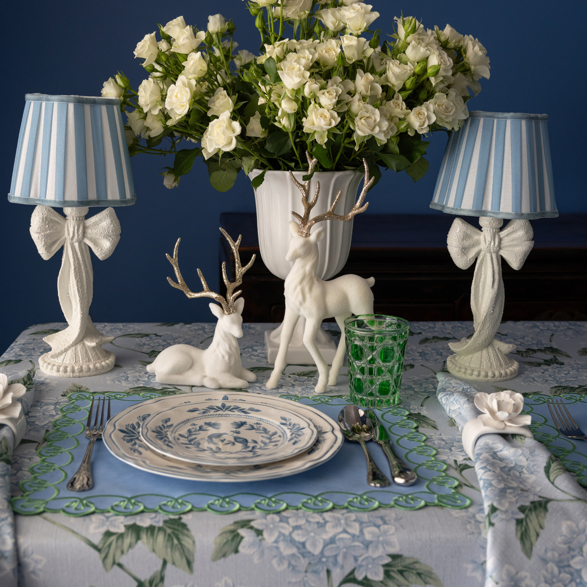 Blue Hydrangea Christmas table styled with white bow lamp, blue stripe lamp shade and cream velvet reindeer