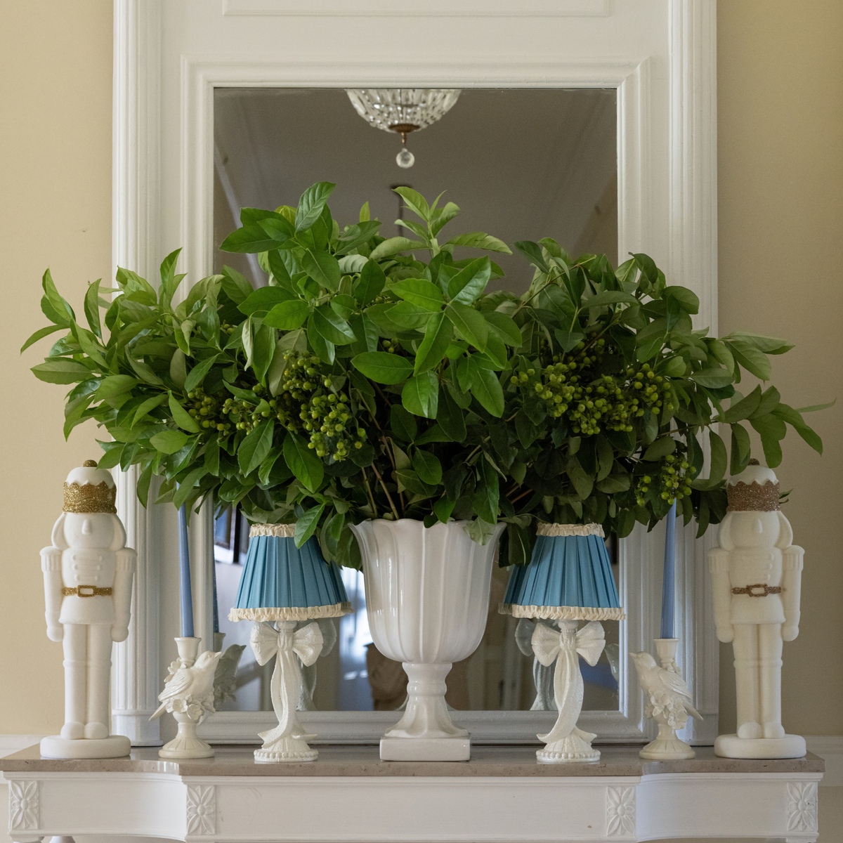 Blue Hydrangea Christmas table styled with cream velvet nutcracker, white bird candle holders and white bow lamp
