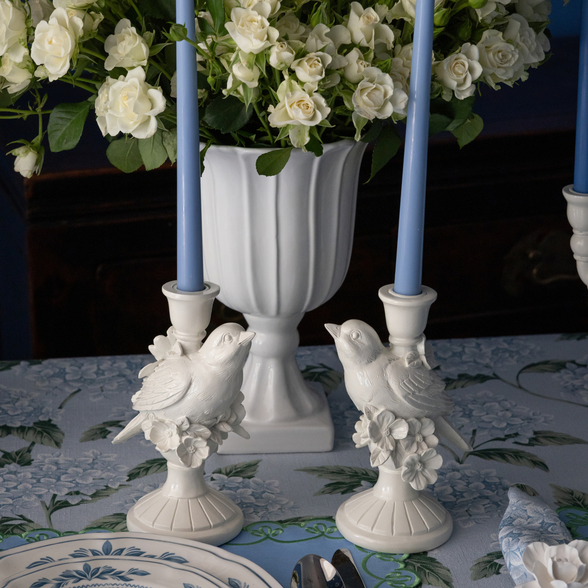Blue Hydrangea Christmas table styled with white bird candle holders and pale blue taper candles