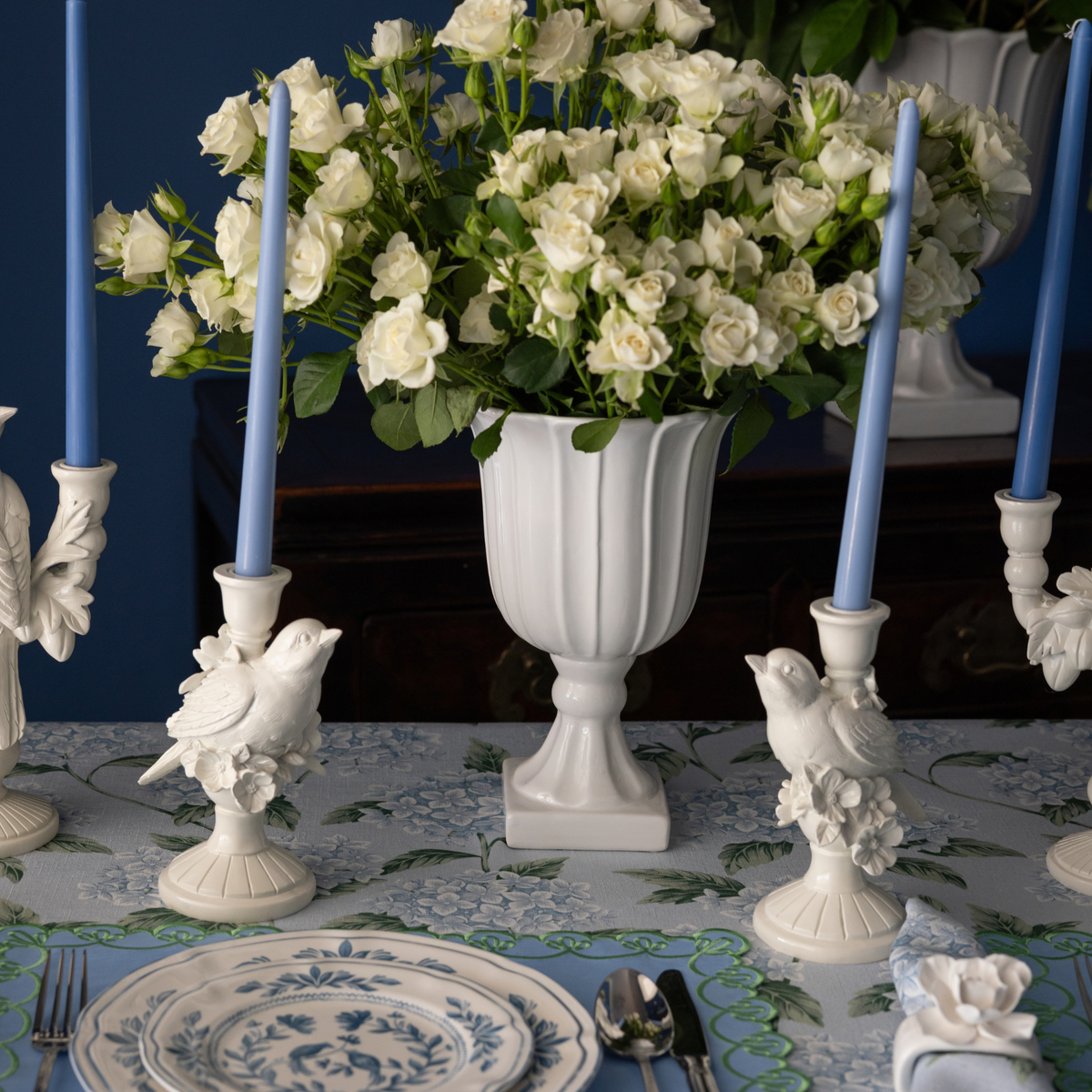 Blue Hydrangea Christmas table styled with white bird candle holders, white bird double candle holder and pale blue taper candles
