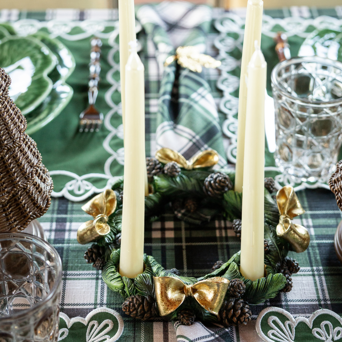 Green and Black Plaid Christmas table styled with pinecone candle ring and ivory taper candles