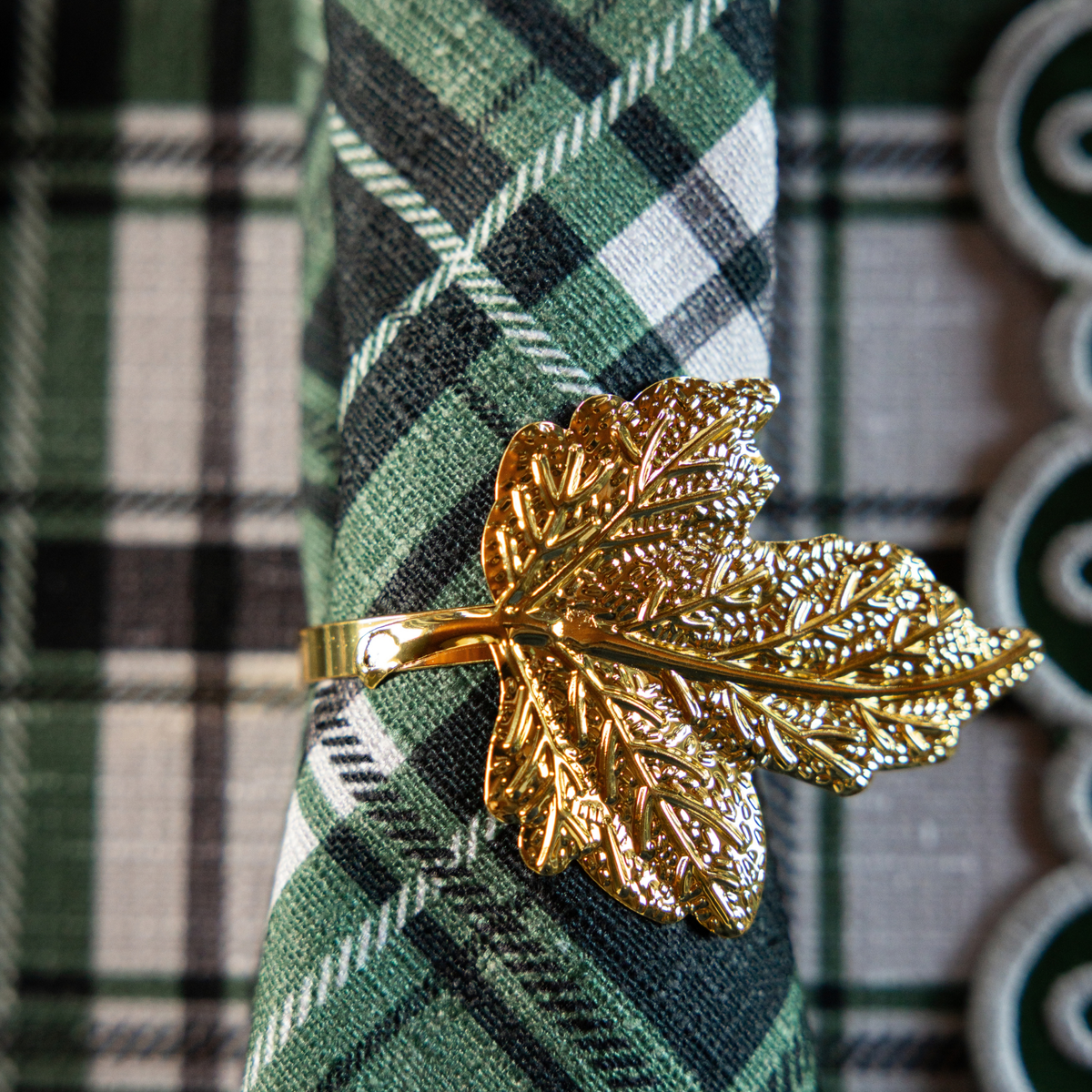 Green and Black Plaid Christmas table styled with gold leaf napkin rings and Green and Black Plaid napkins