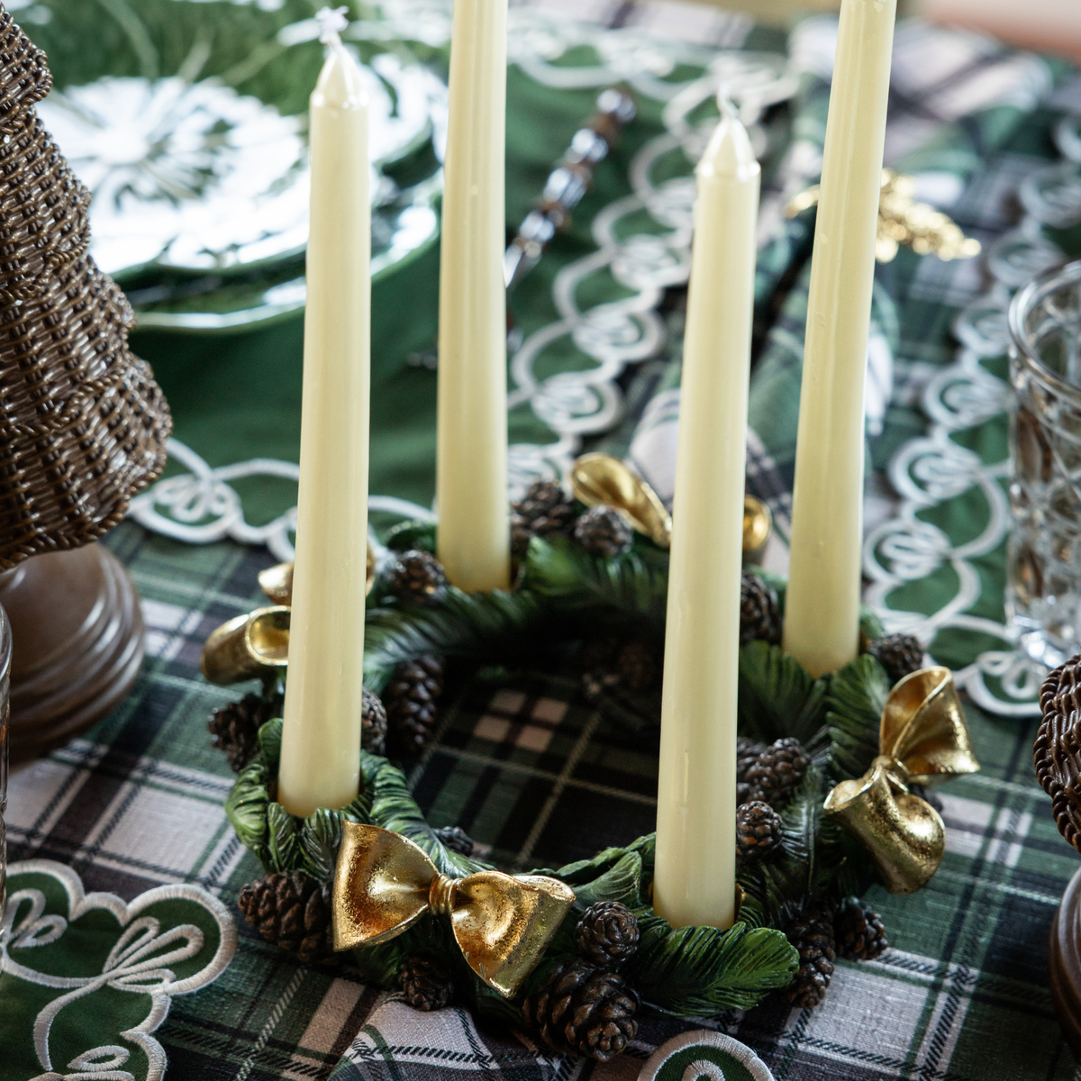 Green and Black Plaid Christmas table styled with pinecone candle ring and ivory taper candles