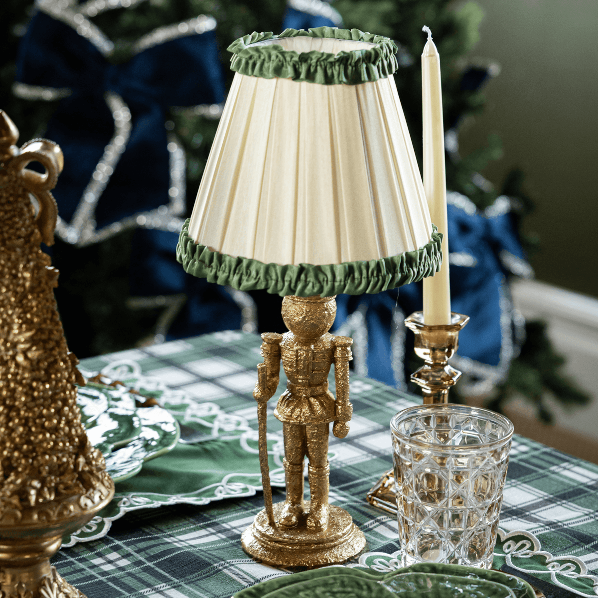 Green and Black Plaid Christmas table styled with gold nutcracker lamp and Audrey cream and hunter green shade