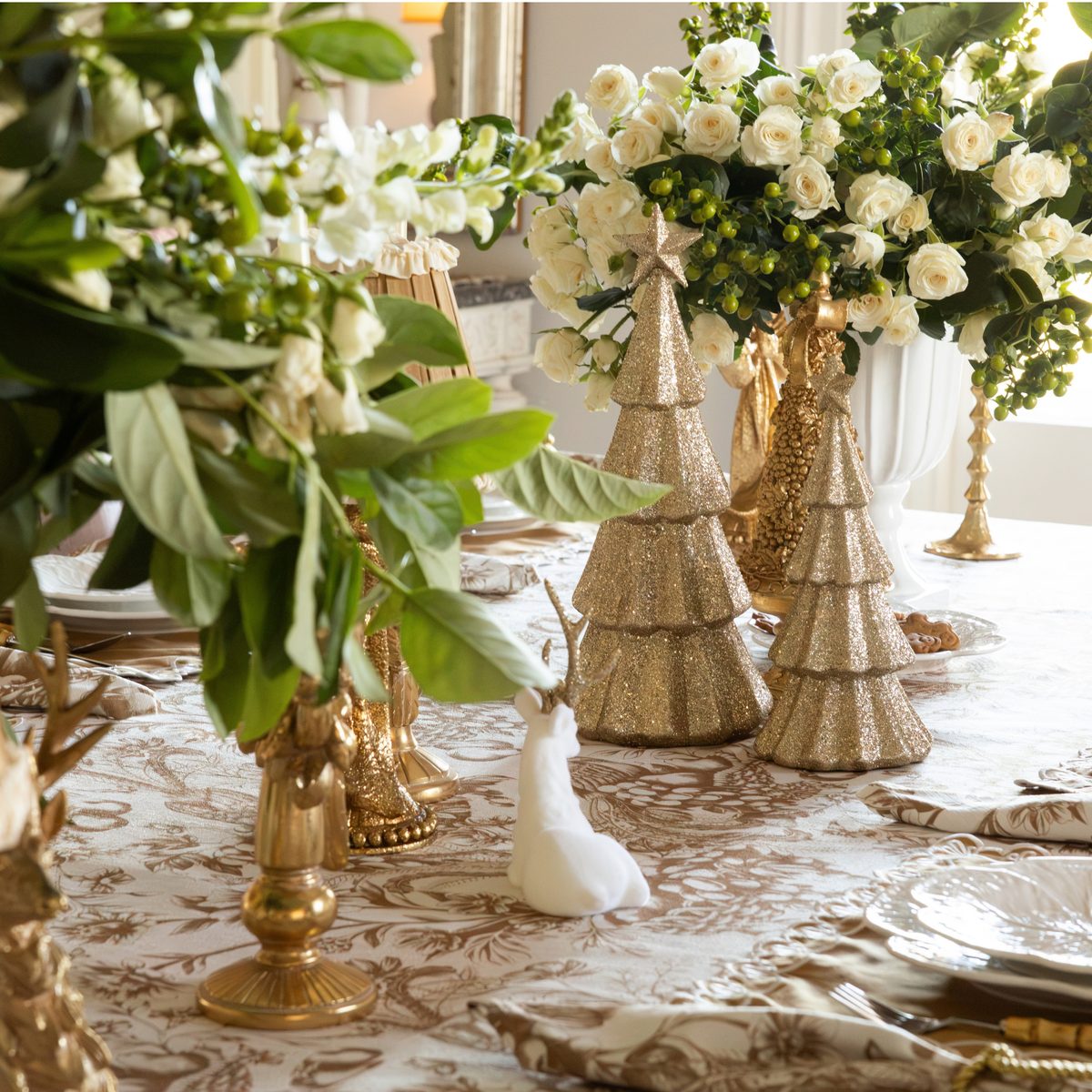 Gold Toile Christmas table styled with champagne glitter Christmas trees, cream velvet reindeer and gold Christmas tree