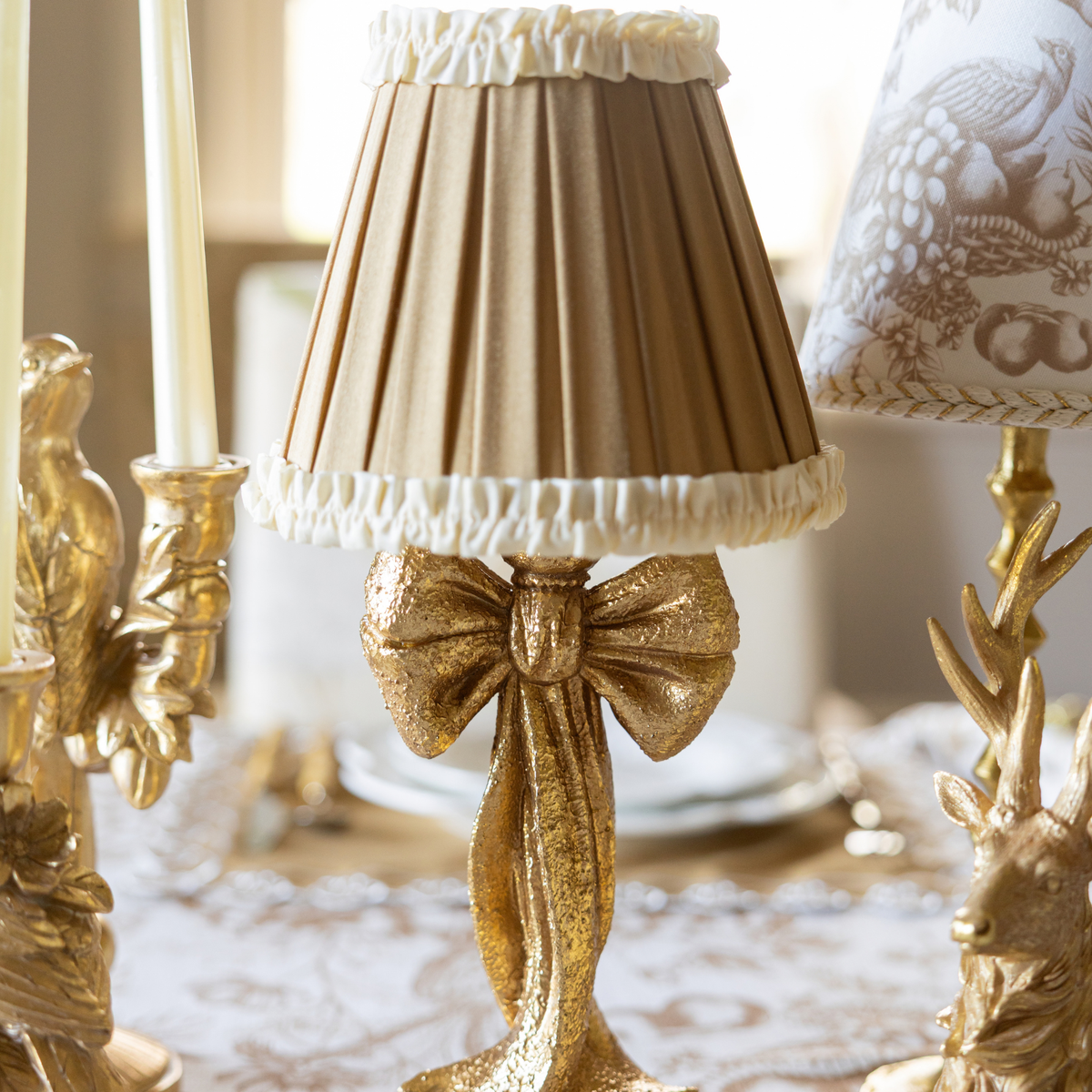Gold Toile Christmas table styled with gold bow lamp and Audrey camel and cream shade