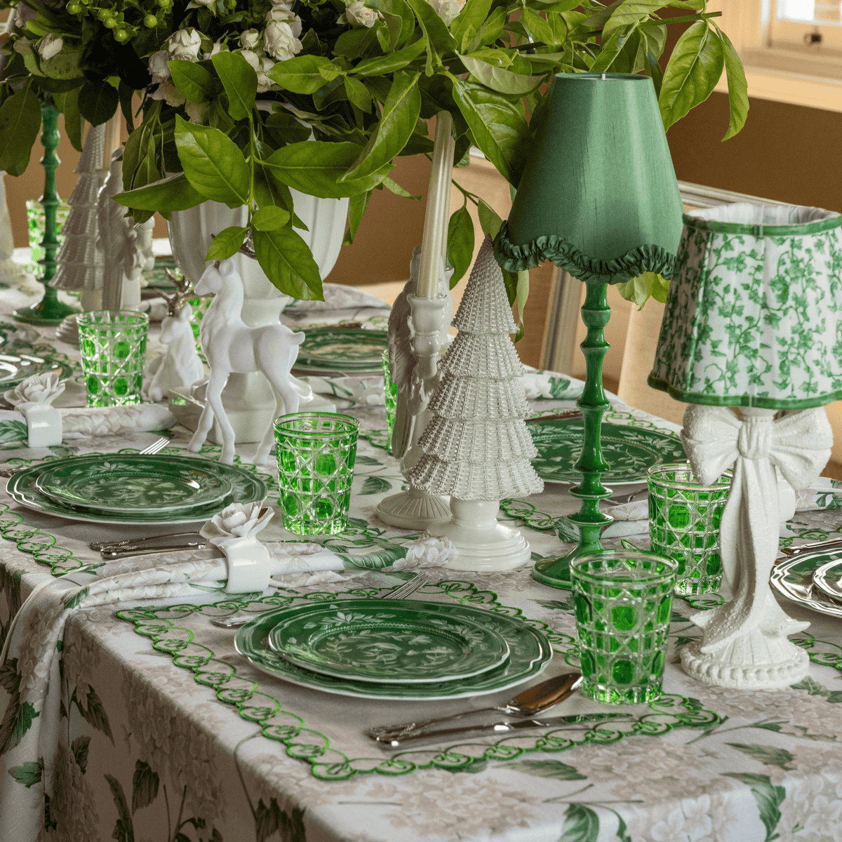 Cream Hydrangea Christmas table styled with white bow lamp, emerald lamp base and olive ruffle lamp shade
