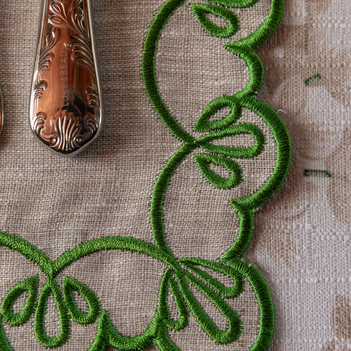 Cream Hydrangea Christmas table styled with natural linen placemats with green embroidery
