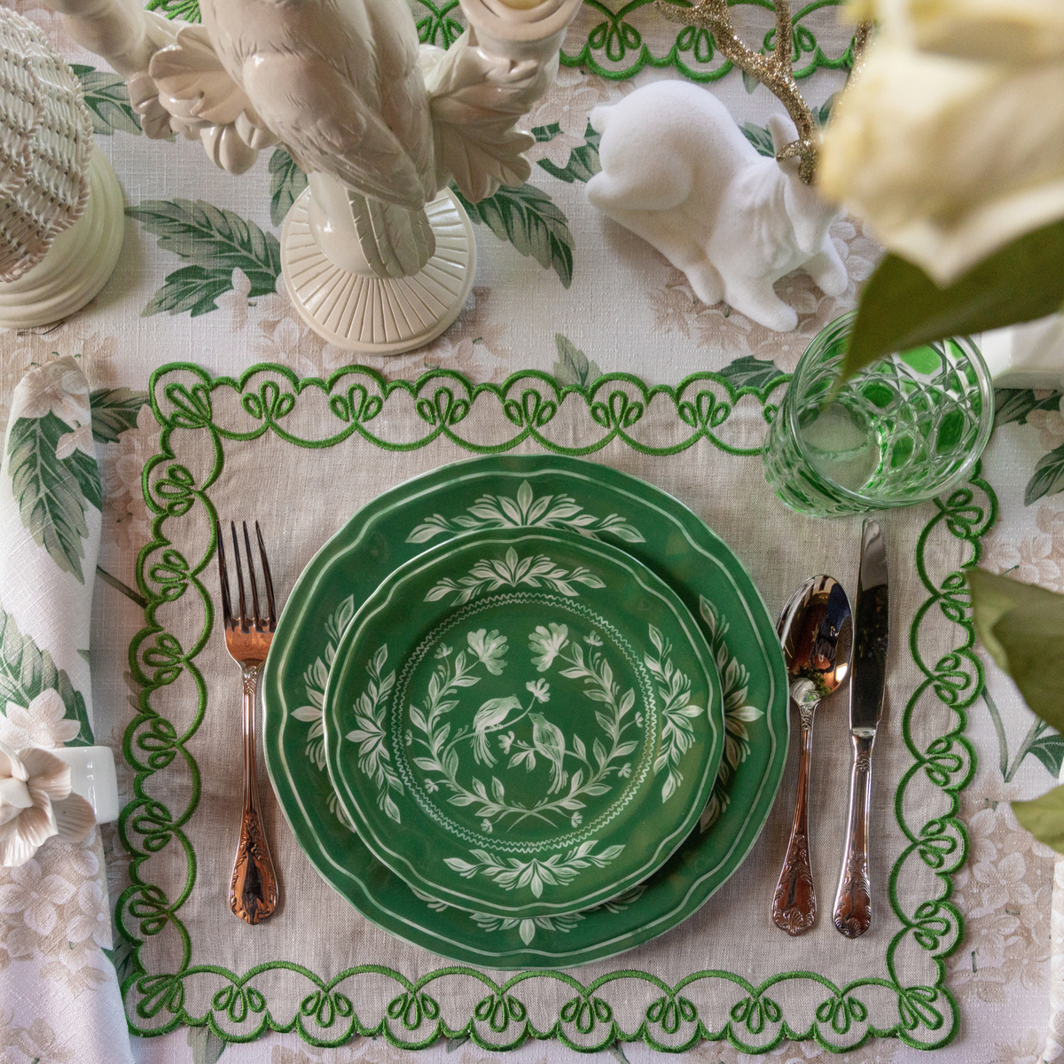 Cream Hydrangea Christmas table styled with green and white Chinoiserie plates and natural linen placemats with green embroidery