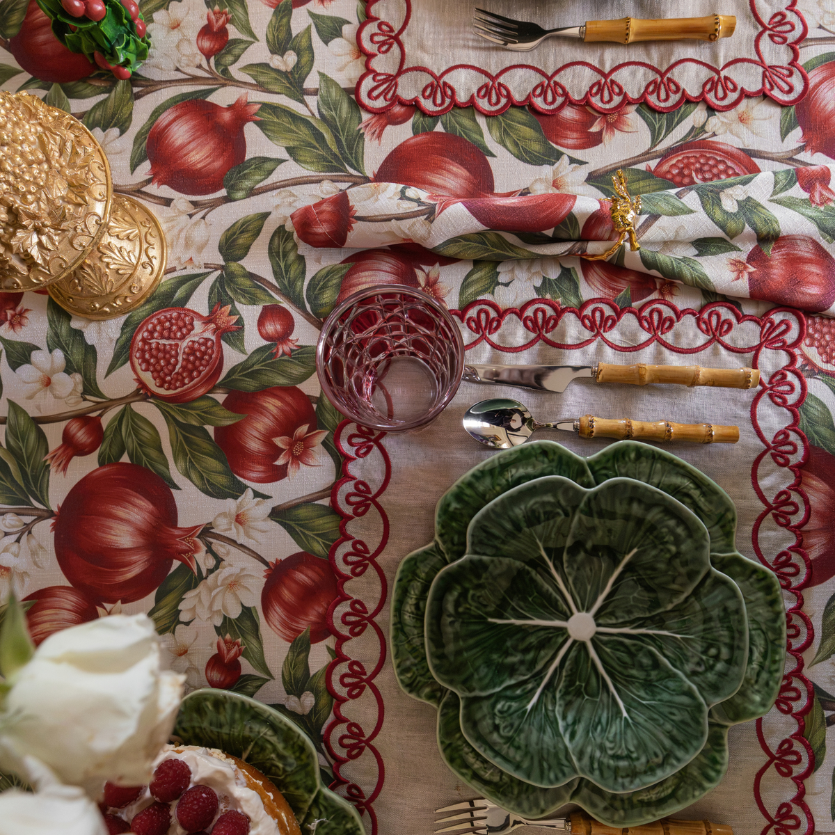 Pomegranate Christmas table styled with green cabbage plates, Pomegranate table cloth and Pomegranate napkins