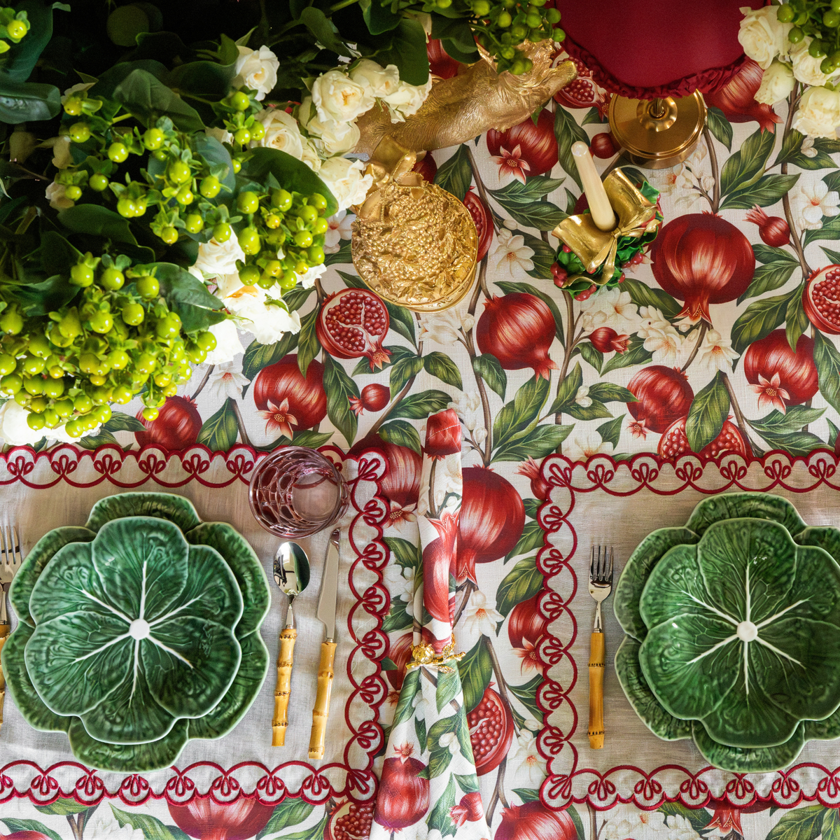 Pomegranate Christmas table styled with Pomegranate table cloth, Pomegranate napkins and natural linen placemats with red embroidery