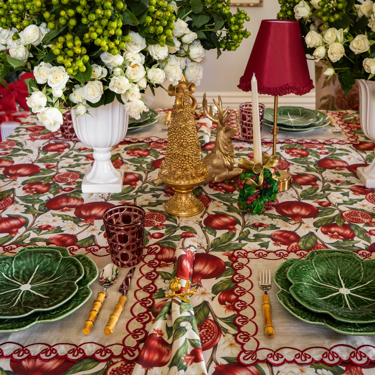 Pomegranate Christmas table styled with Pomegranate table cloth, Pomegranate napkins and natural linen placemats with red embroidery