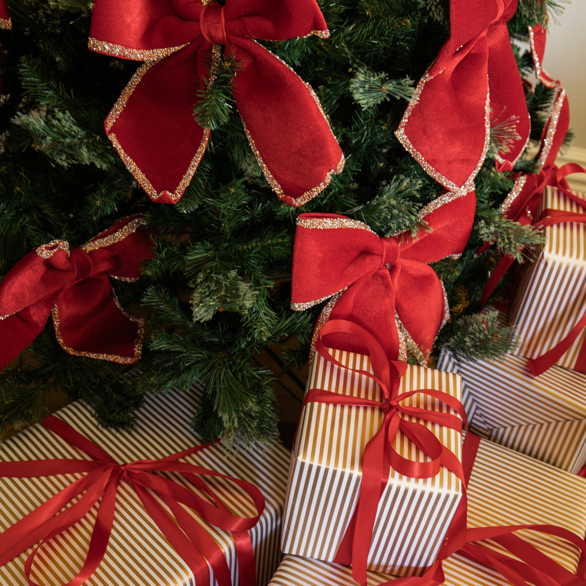 Pomegranate Christmas table styled with red velvet glitter trim bows