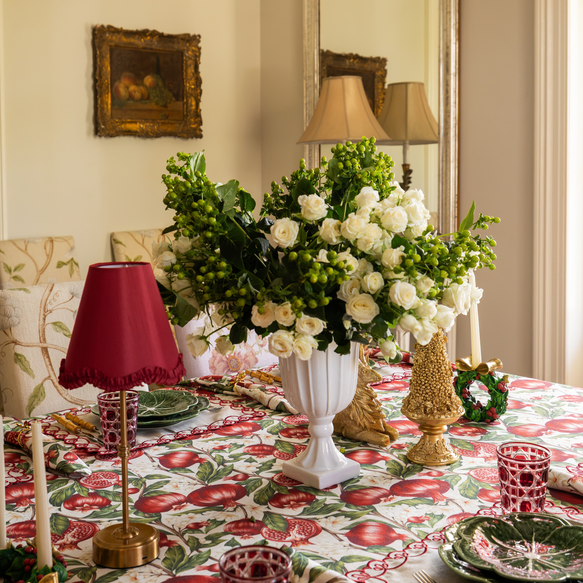 Pomegranate Christmas table styled with Pomegranate table cloth and red ruffle lamp shade