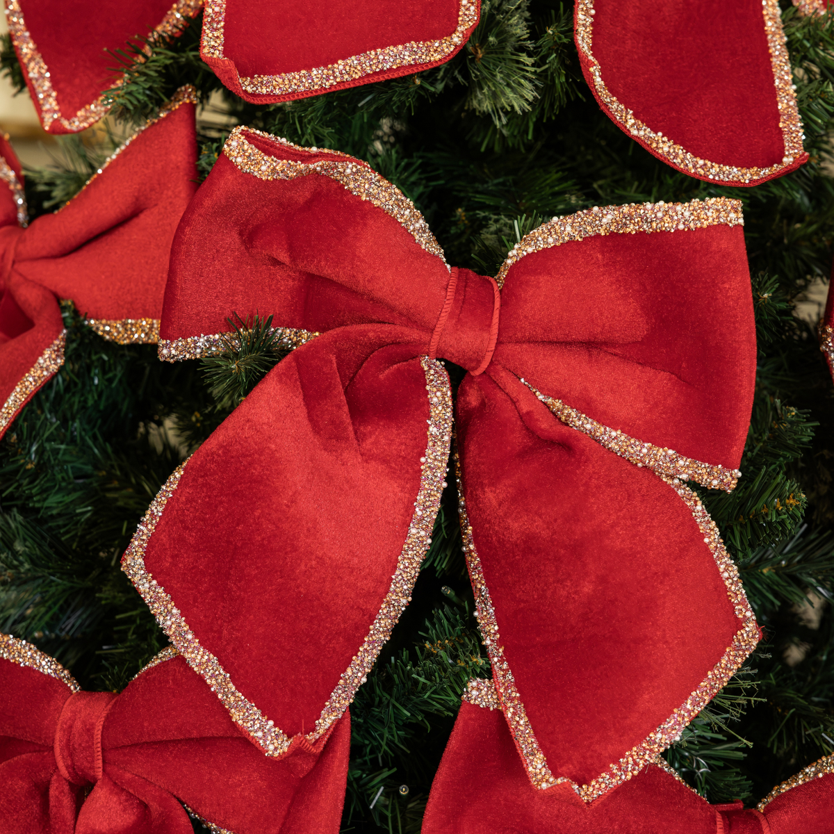 Pomegranate Christmas table styled with red velvet glitter trim bows