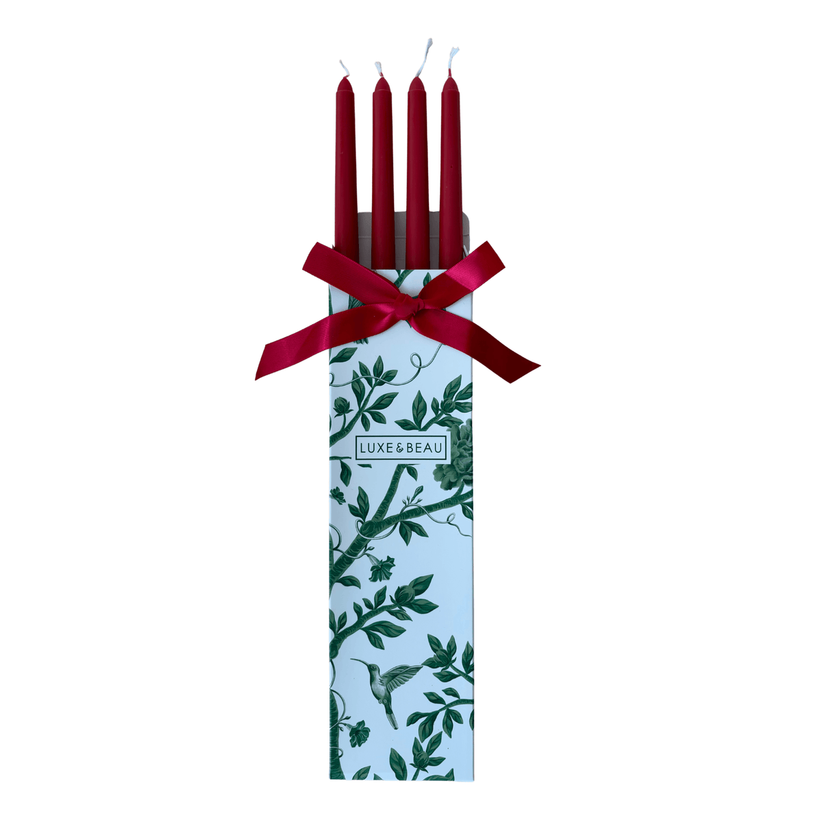 Set of four red taper candles in a Luxe and Beau gift box with red ribbon