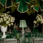 Green Toile Christmas table styled with silver nutcracker lamp, green stripe lamp shade and dark green velvet reindeer