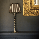 Spruce and Black Bow Christmas table styled with black stripe lamp shade and silver hammered lamp base