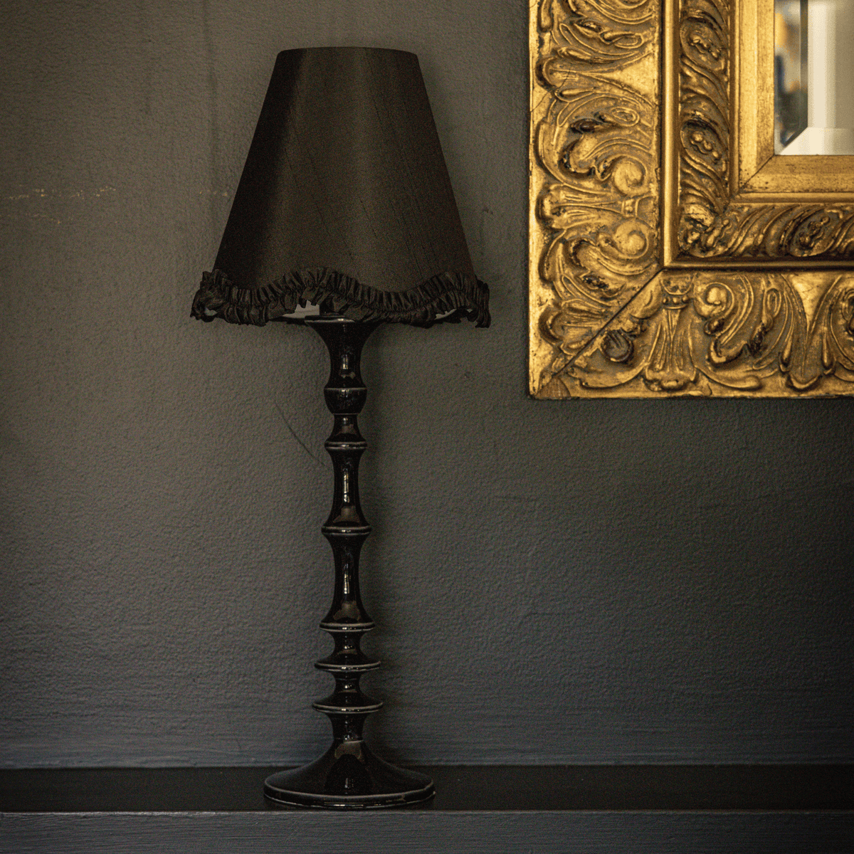 Spruce and Black Bow Christmas table styled with black ruffle lamp shade and black lamp base