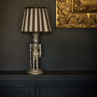 Spruce and Black Bow Christmas table styled with silver nutcracker lamp and black stripe lamp shade