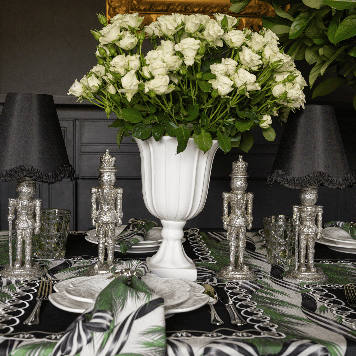 Spruce and Black Bow Christmas table styled with Spruce and Black Bow table cloth, silver nutcracker lamp and black ruffle lamp shade