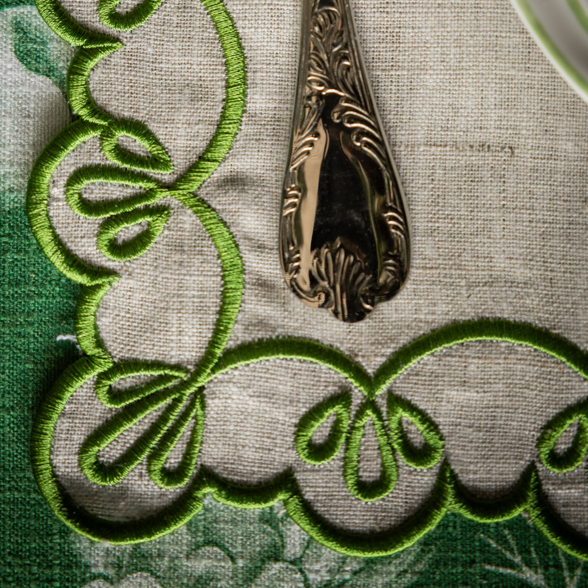 Green Toile Christmas table styled with natural linen placemats with green embroidery
