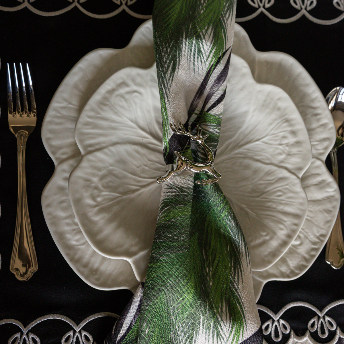 Spruce and Black Bow Christmas table styled with white cabbage plates, silver deer napkin rings and Spruce and Black Bow napkins