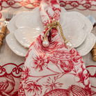 Red Toile Christmas table styled with Red Toile napkins, pearl napkin rings and white cabbage plates