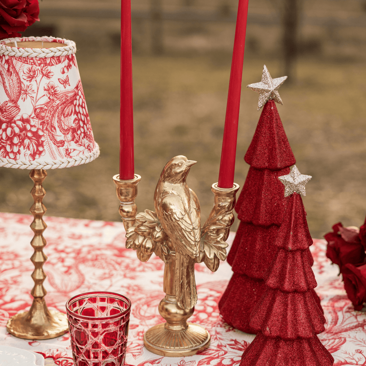 Red Toile Christmas table styled with Red Toile lamp shade, gold hammered lamp base and gold bird double candle holder