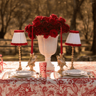 Red Toile Christmas table styled with Audrey snow white and red shade, gold hammered lamp base and gold bird candle holders
