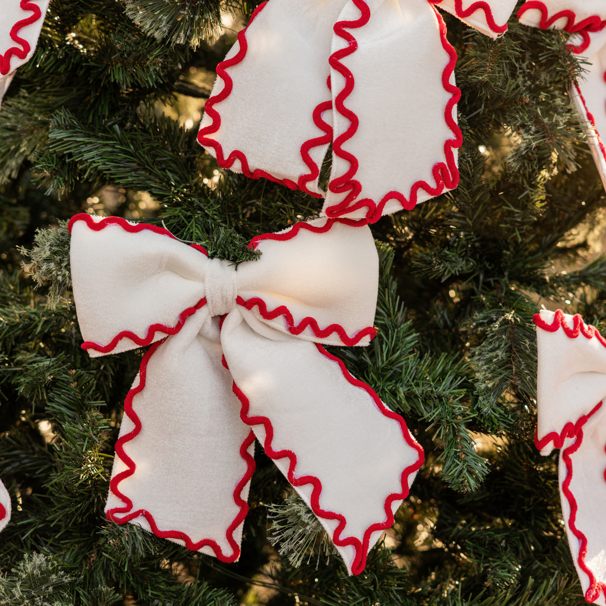 Red Toile Christmas table styled with cream and red ric rac bows