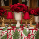 Spruce and Red Bow Christmas table styled with gold bow lamp, red ruffle lamp shade and gold resting reindeer