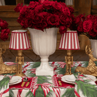 Spruce and Red Bow Christmas table styled with red stripe lamp shade, gold nutcracker lamp and gold resting reindeer