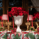 Spruce and Red Bow Christmas table styled with red stripe lamp shade, gold hammered lamp base and gold bow candle holders