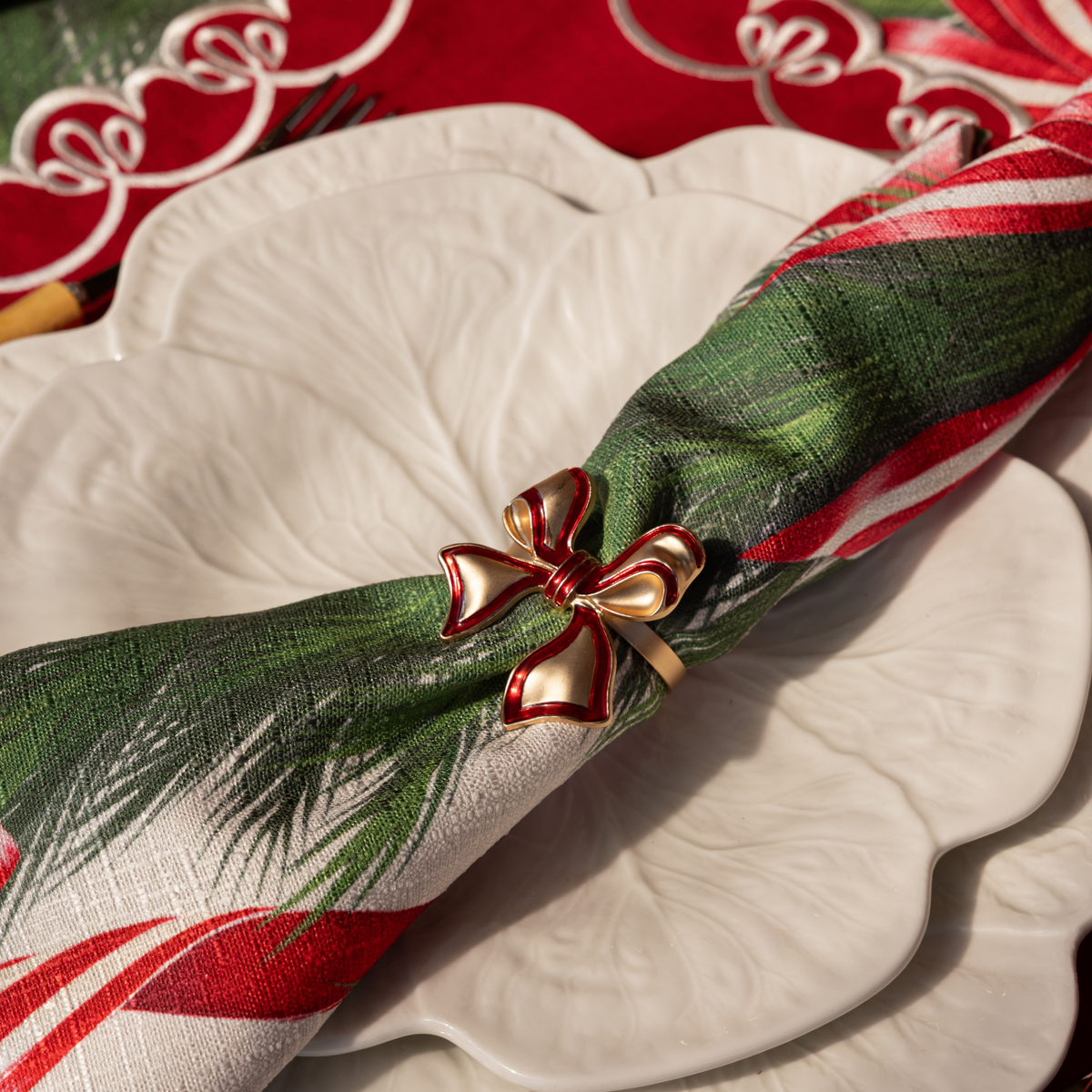 Spruce and Red Bow Christmas table styled with red enamel bow napkin rings and Spruce and Red Bow napkins