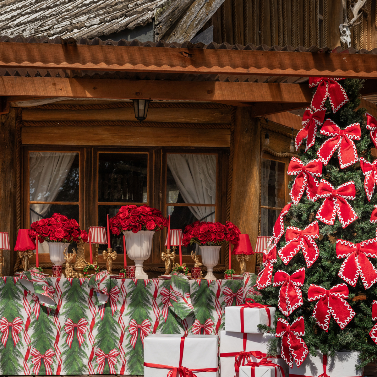 Spruce and Red Bow Christmas table styled with Spruce and Red Bow table cloth and red and ivory ric rac bows