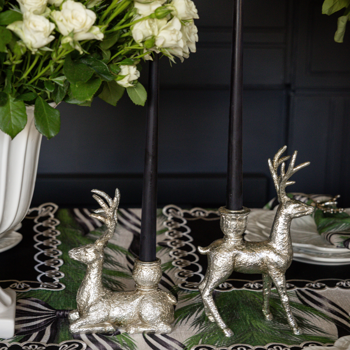 Spruce and Black Bow Christmas table styled with silver deer candle holders and black taper candles