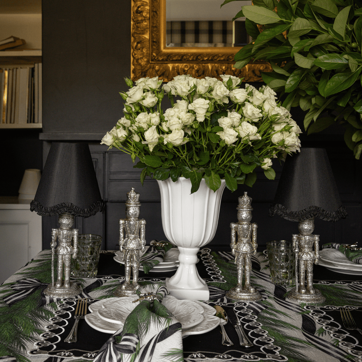 Spruce and Black Bow Christmas table styled with silver nutcracker lamp, black ruffle lamp shade and silver nutcrackers
