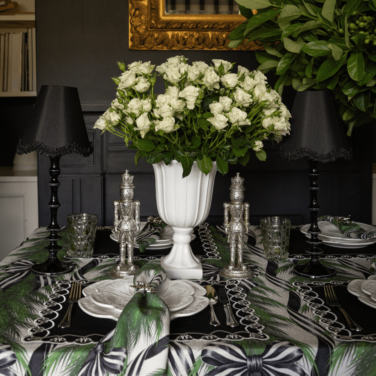 Spruce and Black Bow Christmas table styled with black lamp base, black ruffle lamp shade and silver nutcrackers